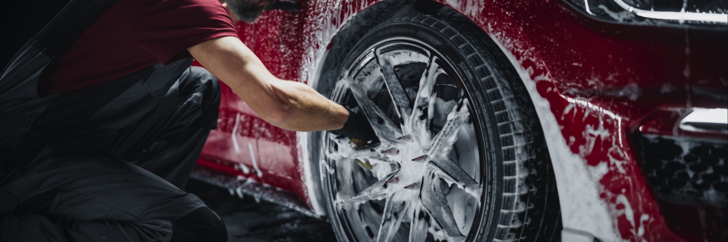 man washing wheels as part of a mobile auto detailing package